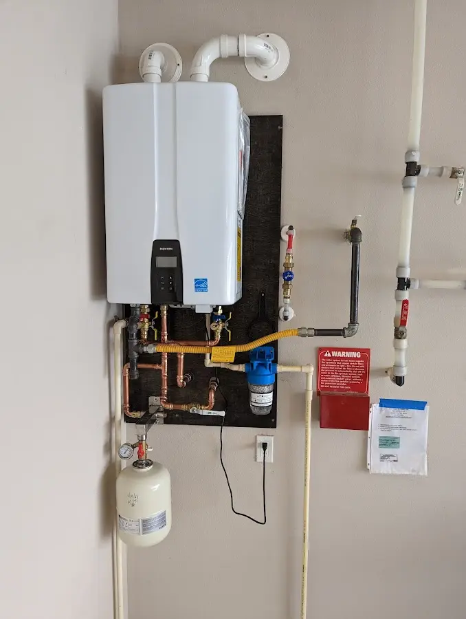 Professional plumber installing copper piping in a Callaway home